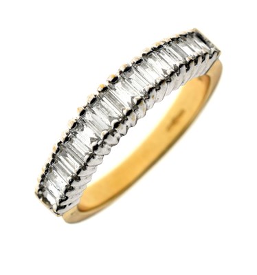 Lot 9 - Baguette cut diamond 18ct gold half eternity ring