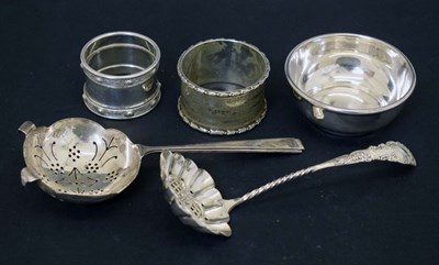 Lot 171 - Elizabeth II silver tea strainer and stand, silver sifting spoon, and two silver napkin rings