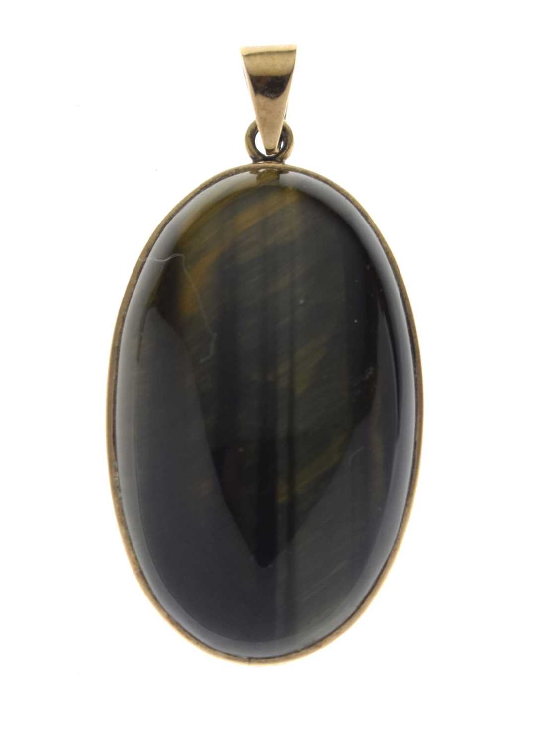 Lot 43 - Tigers eye yellow metal pendant