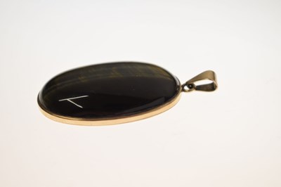 Lot 43 - Tigers eye yellow metal pendant