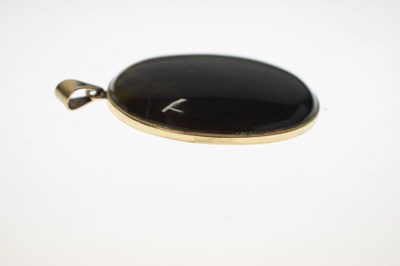 Lot 43 - Tigers eye yellow metal pendant