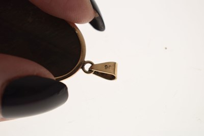 Lot 43 - Tigers eye yellow metal pendant