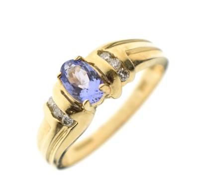 Lot 119 - Tanzanite and diamond yellow metal dress ring, stamped '18K'