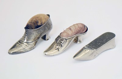 Lot 260 - Three novelty white-metal miniature boots