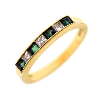 Lot 110 - Emerald and diamond 18ct gold half eternity ring