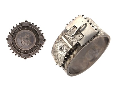 Lot 208 - Victorian silver hinged buckle bangle and a white-metal mourning brooch
