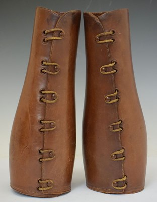 Lot 340 - Pair of early 20th century brown leather leg guards