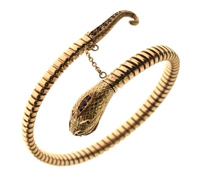 Lot 200 - Gem-set 9ct gold coiled serpent / snake bangle