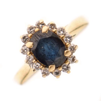 Lot 26 - Sapphire and diamond 18ct yellow metal cluster ring