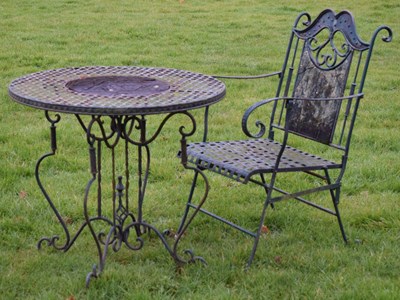 Lot 638 - Black painted wrought and cast metal patio table