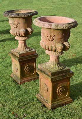 Lot 530 - Pair of terracotta coloured composition pedestal urns