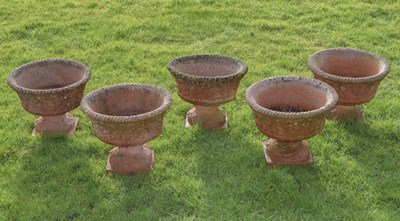 Lot 532 - Set of five 'Sandford Stone' terracotta coloured composition pedestal garden planters