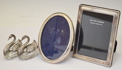 Lot 40 - Two silver-mounted photograph frames and two white-metal swan salts
