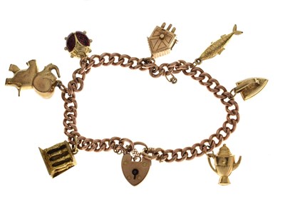 Lot 128 - 9ct 'rose gold' curb link charm bracelet with charms, 31g gross approx