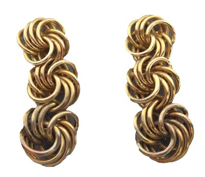 Lot 133 - Pair of triple knot yellow metal drop earrings