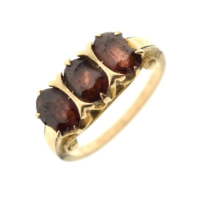 Lot 43 - Garnet three-stone dress ring, stamped '10K' (a/f)