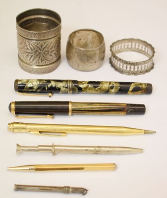 Lot 318 - Collection of pens, etc together with three silver / white metal napkin rings