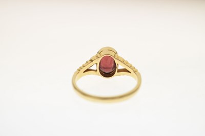 Lot 24 - Early to mid 20th century garnet yellow metal ring stamped '18ct'