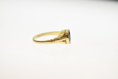 Lot 24 - Early to mid 20th century garnet yellow metal ring stamped '18ct'