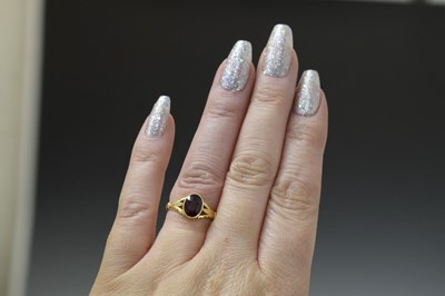 Lot 24 - Early to mid 20th century garnet yellow metal ring stamped '18ct'