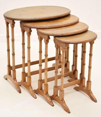 Lot 564 - Walnut nest of four oval occasional tables