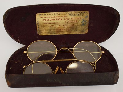 Lot 301 - Two pairs of early 20th century gentleman's yellow metal spectacles