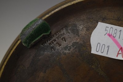 Lot 266 - Tiffany Studios, a counter-balance patinated bronze desk lamp with ‘favrile’ glass shade