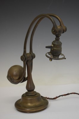 Lot 266 - Tiffany Studios, a counter-balance patinated bronze desk lamp with ‘favrile’ glass shade