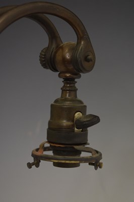 Lot 266 - Tiffany Studios, a counter-balance patinated bronze desk lamp with ‘favrile’ glass shade