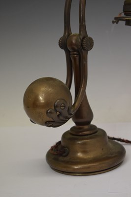 Lot 266 - Tiffany Studios, a counter-balance patinated bronze desk lamp with ‘favrile’ glass shade