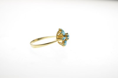 Lot 26 - Iranian turquoise yellow metal flower head dress ring