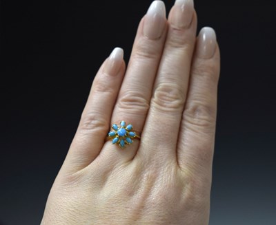 Lot 26 - Iranian turquoise yellow metal flower head dress ring