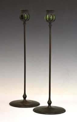Lot 243 - Attributed to Tiffany Studios - Pair of patinated bronze candlesticks