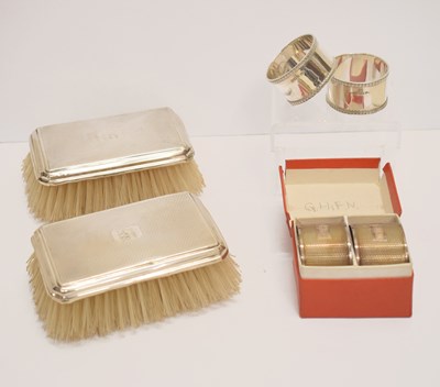 Lot 193 - Two pairs of silver napkin rings, and a pair of George V silver-backed brushes