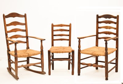 Lot 794 - Three 19th century rush-seated ash ladderback armchairs (one a rocking chair)