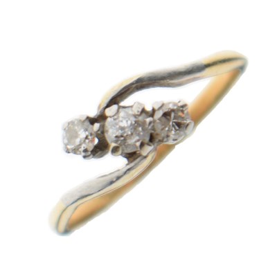 Lot 4 - Three-stone diamond crossover ring, stamped '18ct'