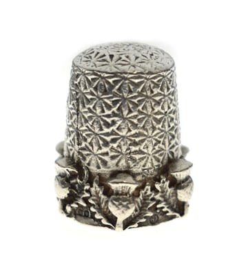 Lot 220 - Elizabeth II Scottish cast silver thimble with thistle decoration