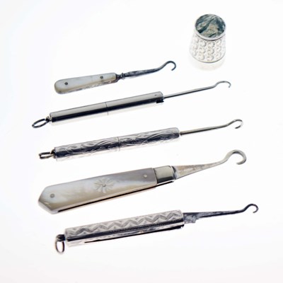 Lot 227 - An Elizabeth II silver thimble, together with five assorted retractable button hooks