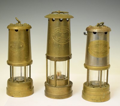 Lot 431 - Three brass miner's lamps