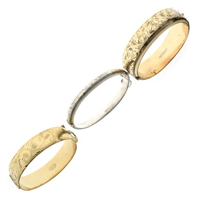 Lot 116 - Two rolled gold snap bangles plus a silver bangle