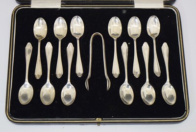 Lot 244 - Cased dozen George V silver Sheraton pattern demi tasse coffee spoons and sugar tongs