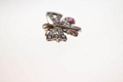 Lot 43 - Diamond, ruby and sapphire yellow and white metal pendant brooch in the form of a butterfly