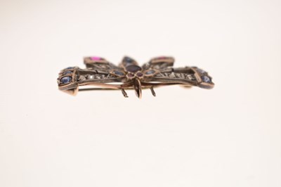 Lot 43 - Diamond, ruby and sapphire yellow and white metal pendant brooch in the form of a butterfly
