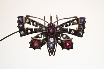 Lot 43 - Diamond, ruby and sapphire yellow and white metal pendant brooch in the form of a butterfly