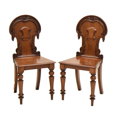 Lot 789 - Pair of mid Victorian carved mahogany hall chairs
