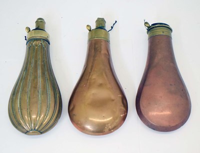 Lot 492 - Three copper and brass powder flasks
