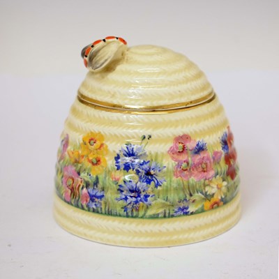 Lot 554 - Clarice Cliff 'Radiance' pattern beehive honey jar and cover