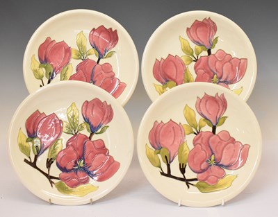 Lot 567 - Moorcroft - Four plated decorated in the Magnolia pattern