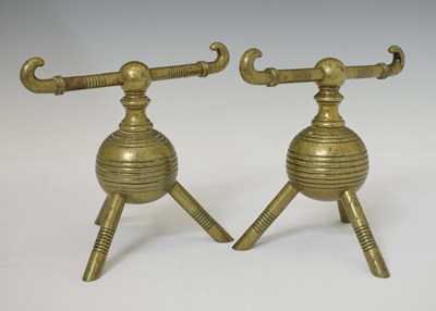 Lot 466 - Attributed to Dr Christopher Dresser, a pair of Aesthetic Movement brass fire dogs