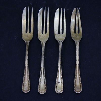 Lot 277 - Set of four George V silver cake forks